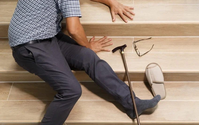 Senior man with stick falling down stair