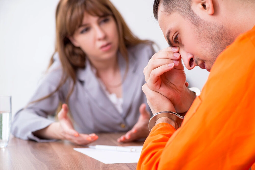 Young man meeting with advocate in pre-trial detention