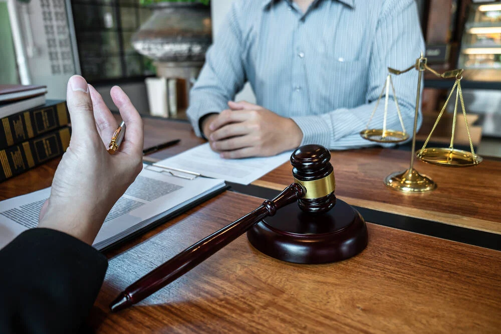 Professional male lawyer or counselor discussing negotiation legal case with client meeting