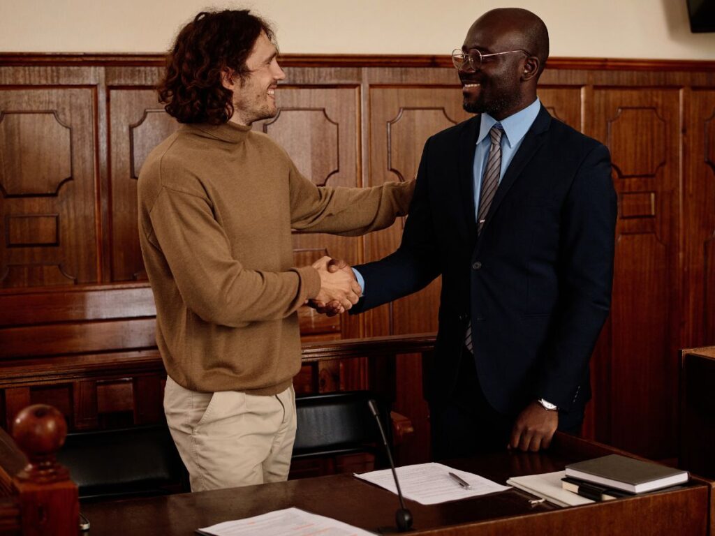 First DUI court appearance in California: A defendant shaking hands with his attorney in court.