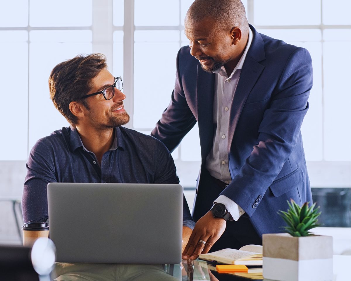 Criminal Defense Lawyer Shaffer Cormell: A happy client in an office setting, successfully overcoming a criminal record.