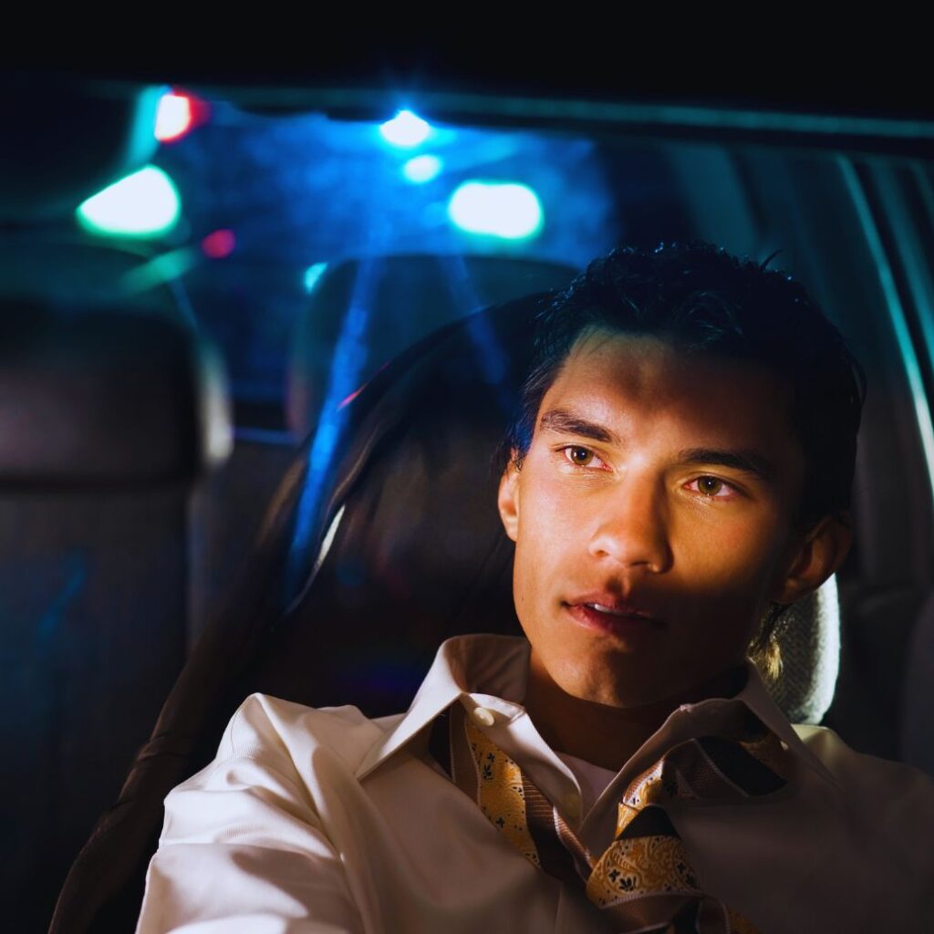 Alt Text: DUI causing injury: A driver being pulled over by police for impaired driving, highlighting the serious consequences and dangers of DUI.