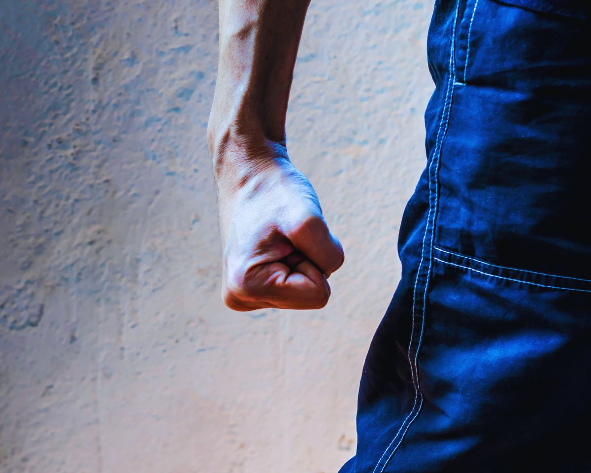 A man representing both simple assault and aggravated assault charges, showcasing legal distinctions.