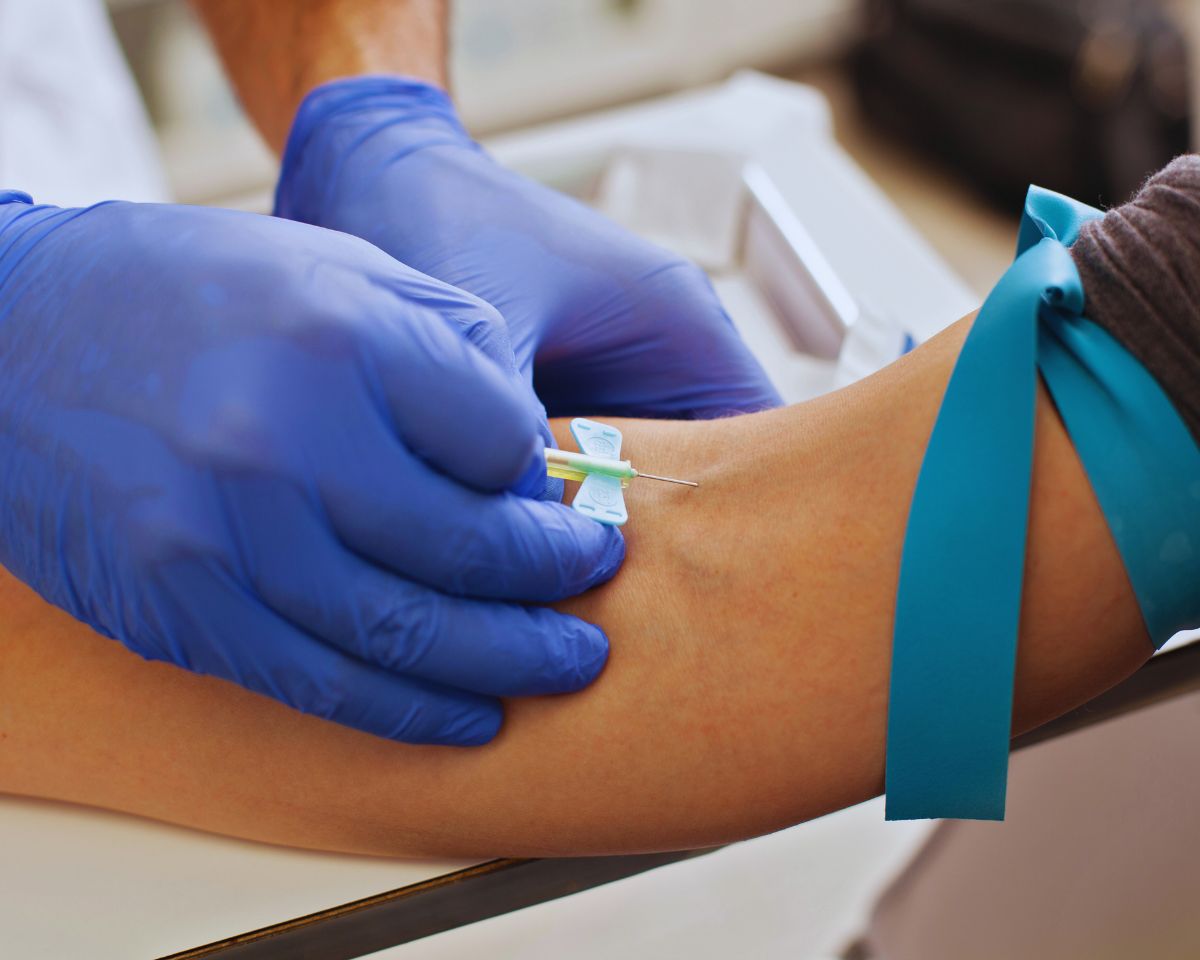 Law enforcement officer administering a DUI blood test as an alternative to field sobriety tests during a DUI stop.