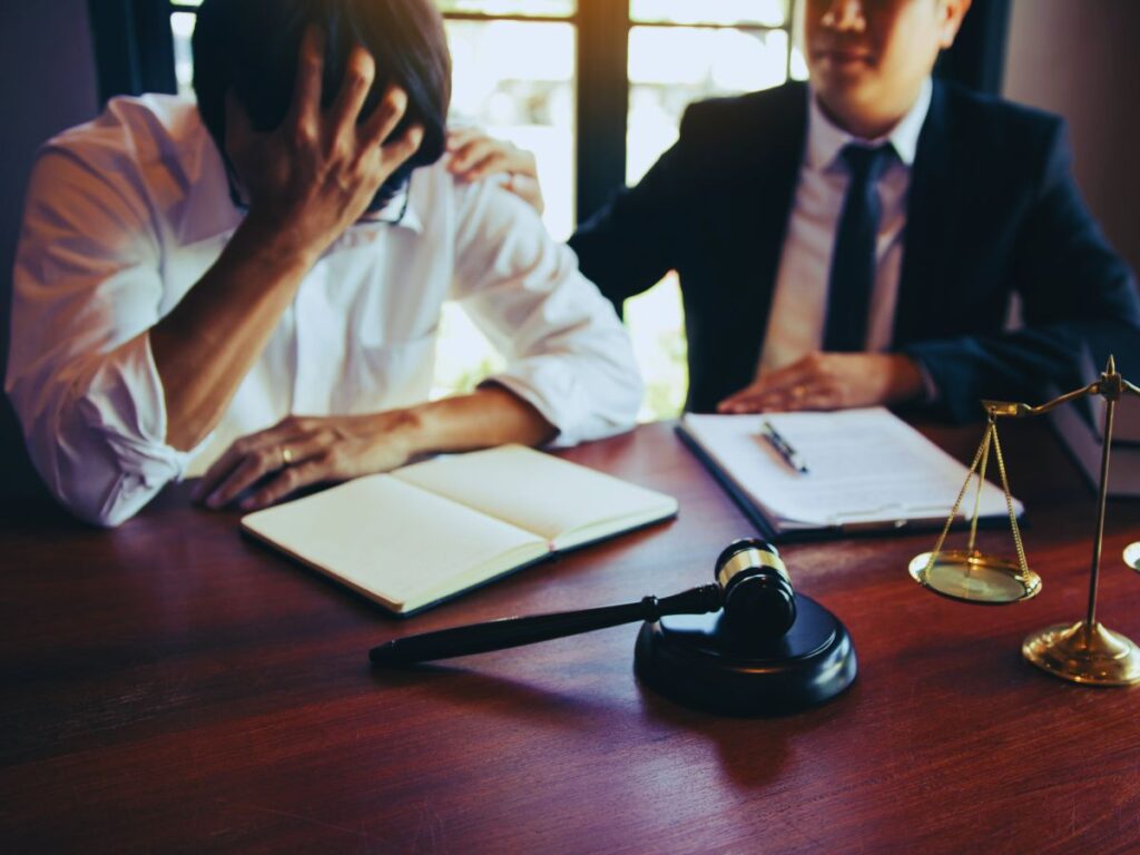 A worried client sits with their criminal defense attorney in Southern California, discussing the serious implications of a violation of probation.