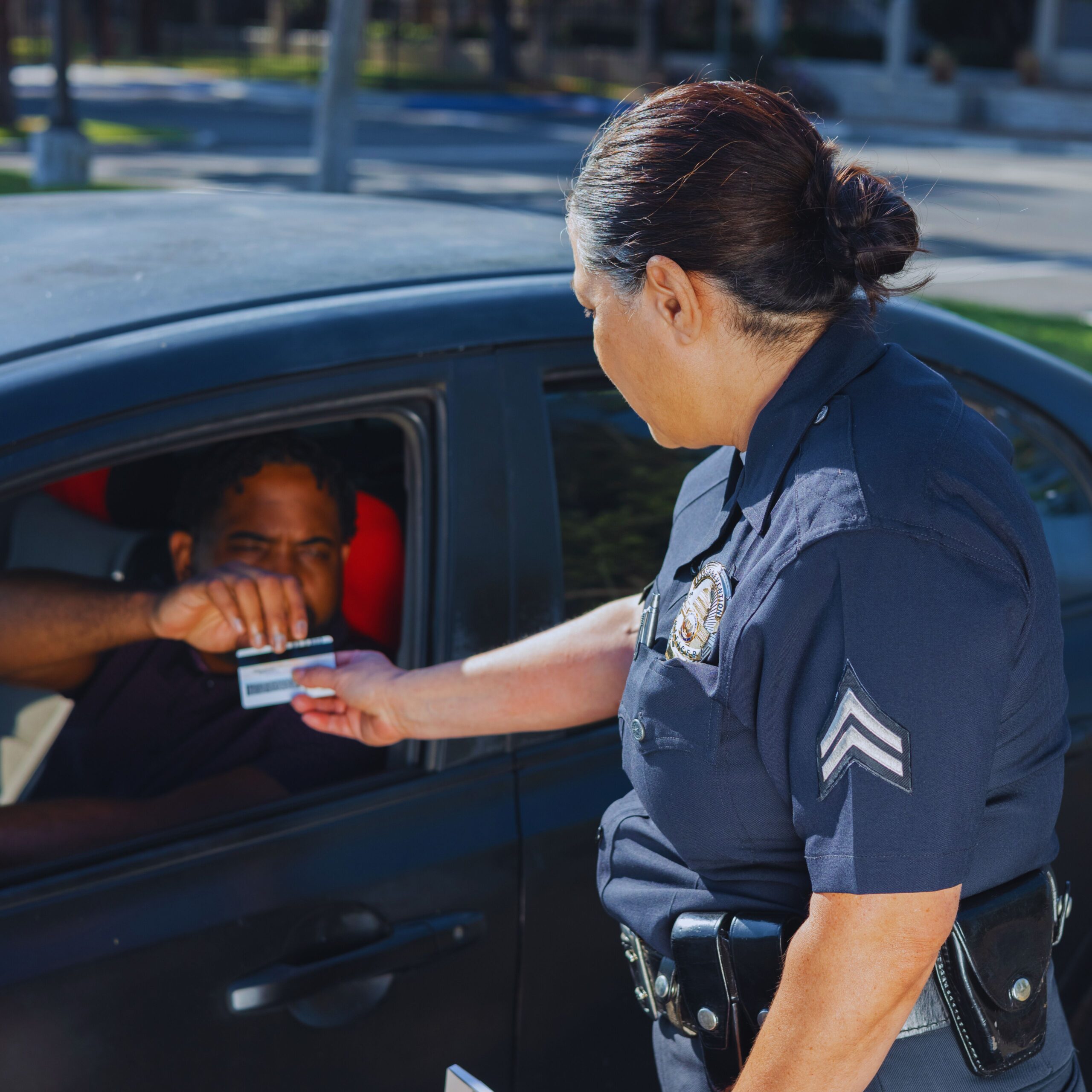 Drivers License in California: The driver is showing his driver's license to a police officer.